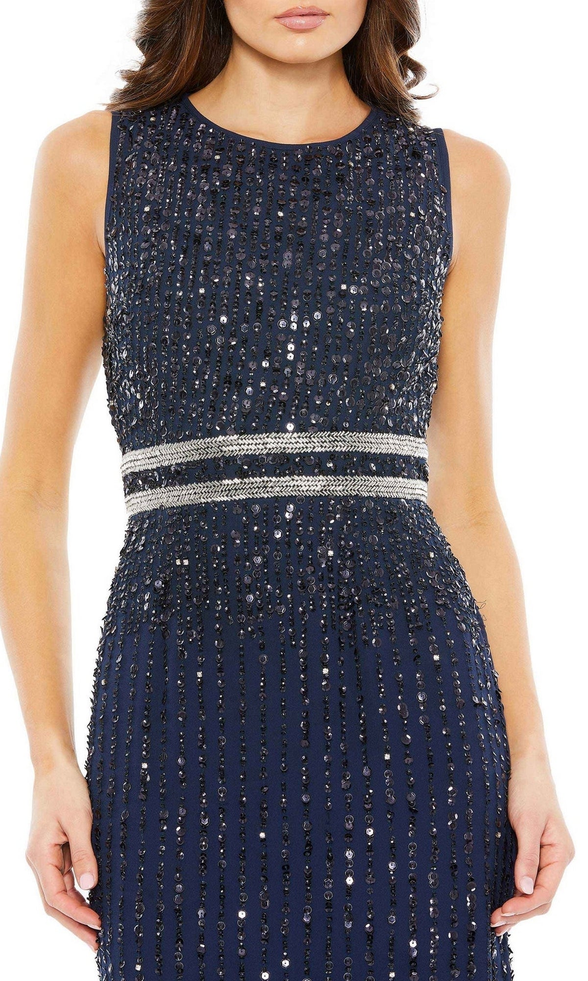 A woman wears the Sleeveless Sequin Formal Dress: Mac Duggal 93603, a navy blue gown with sequins and a silver embellished waistband, perfect for formal evenings.
