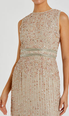 A woman wearing the Mac Duggal 93603 Sleeveless Sequin Formal Dress, a beige gown with vertical rows of sequins and beads and a defined waistband.