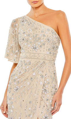 A woman wears the Long Formal Dress 93635 by Mac Duggal—beige, one-shoulder design featuring floral embellishments, sequin accents, and a sheer draped sleeve.