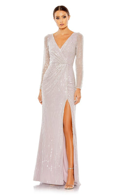 A woman stands against a white background wearing the Mac Duggal 93660 Lavender Sequin Formal Dress, featuring long sleeves, a V-neckline, light-colored sequins, and a high slit.