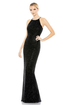A woman poses against a white background in the Mac Duggal 93742, a long black beaded formal dress with a sleeveless design and high neckline.