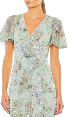Woman wearing the Mac Duggal 93749 Short Sleeve Beaded Formal Dress—light green with floral pattern, sequins, V-neckline, and short sleeves.
