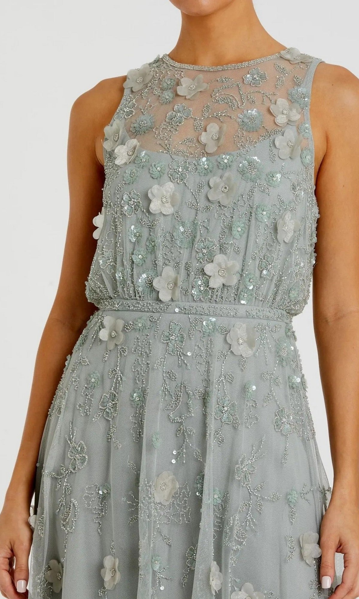 A woman wearing the Midi Party Dress: Mac Duggal 9380—a sleeveless, sage-green party dress adorned with beaded floral embroidery, delicate bead details, and a sheer neckline.