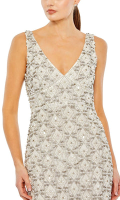 A woman wears the Mac Duggal Short Wedding Guest Dress 93807, a fitted black beaded dress with an ankle-length, sleeveless V-neck design adorned with intricate beadwork and sequin patterns.