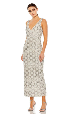 Woman wearing the Short Wedding Guest Dress 93807 by Mac Duggal— a fitted silver sleeveless dress with intricate beading—paired with silver heels, standing against a white background.