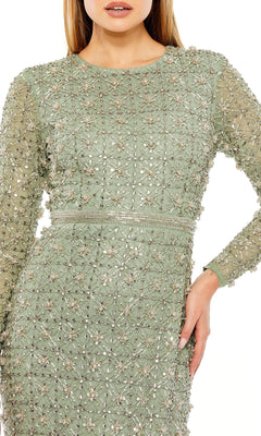 A woman models the Long Formal Dress 93827 by Mac Duggal—a light green, long sleeve gown featuring intricate beaded floral embroidery, cropped at the shoulders and mid-thigh for a modern update on formal style.