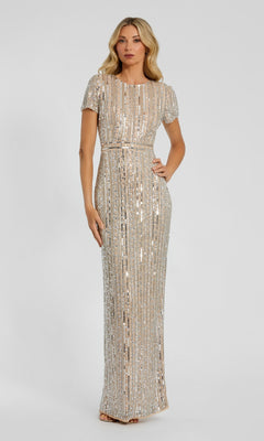 A woman stands against a plain light background, hands at her sides, wearing the Mac Duggal 93829 long formal dress with short sleeves, floor-length design, and vertical linear sequins.