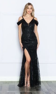 A woman stands against a plain white wall wearing the Long Black Sequin Cold-Shoulder Prom Dress 9384, featuring sparkling sequins and a thigh-high slit.