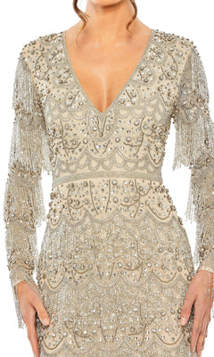 A woman wears the Mac Duggal 93861 Long Sleeve Beaded Formal Dress, a V-neck tea-length gown adorned with silver sequins, beads, and fringe.