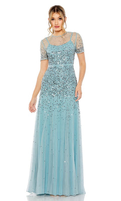 A woman wearing the Mac Duggal Sheer High-Neck Sequin Formal Dress 93909, a floor-length light blue gown with short sheer sleeves and silver embellishments, stands against a white background.