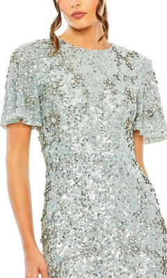 Woman wearing the Long Formal Dress 93932 by Mac Duggal in French blue, featuring short sleeves and floral sequin patterns, shown from shoulders to upper legs.