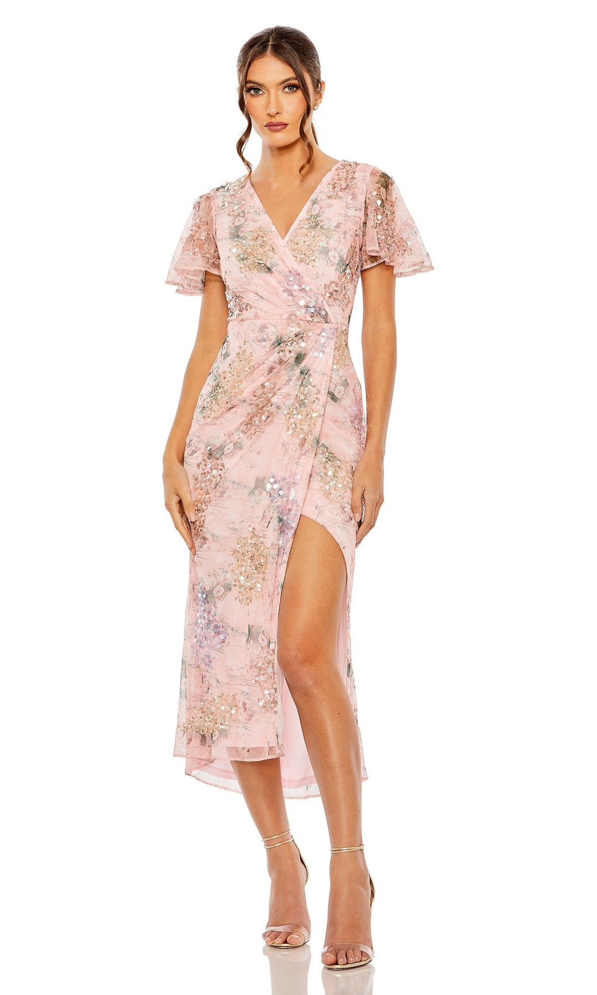 Woman wearing the Mac Duggal 93949 Midi Wedding Guest Dress in rose, featuring short sleeves, a floral wrap design, side slit, and high-low hemline, paired with strappy heels.