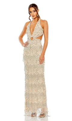 A woman poses in the Mac Duggal Backless Beaded Formal Dress 93956, a floor-length, sleeveless gown with a plunging v-neck, cutout sides, ring detail at the waist, and layered beaded fringe embellishments.