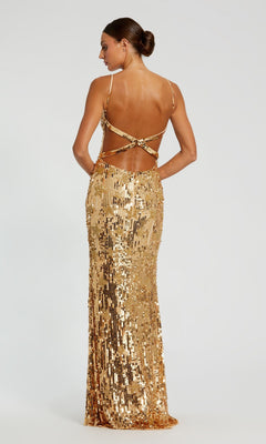 A woman faces away, wearing the Long Formal Dress 93968 by Mac Duggal—a floor-length gold sequin gown featuring thin straps and an elegant open-back design.