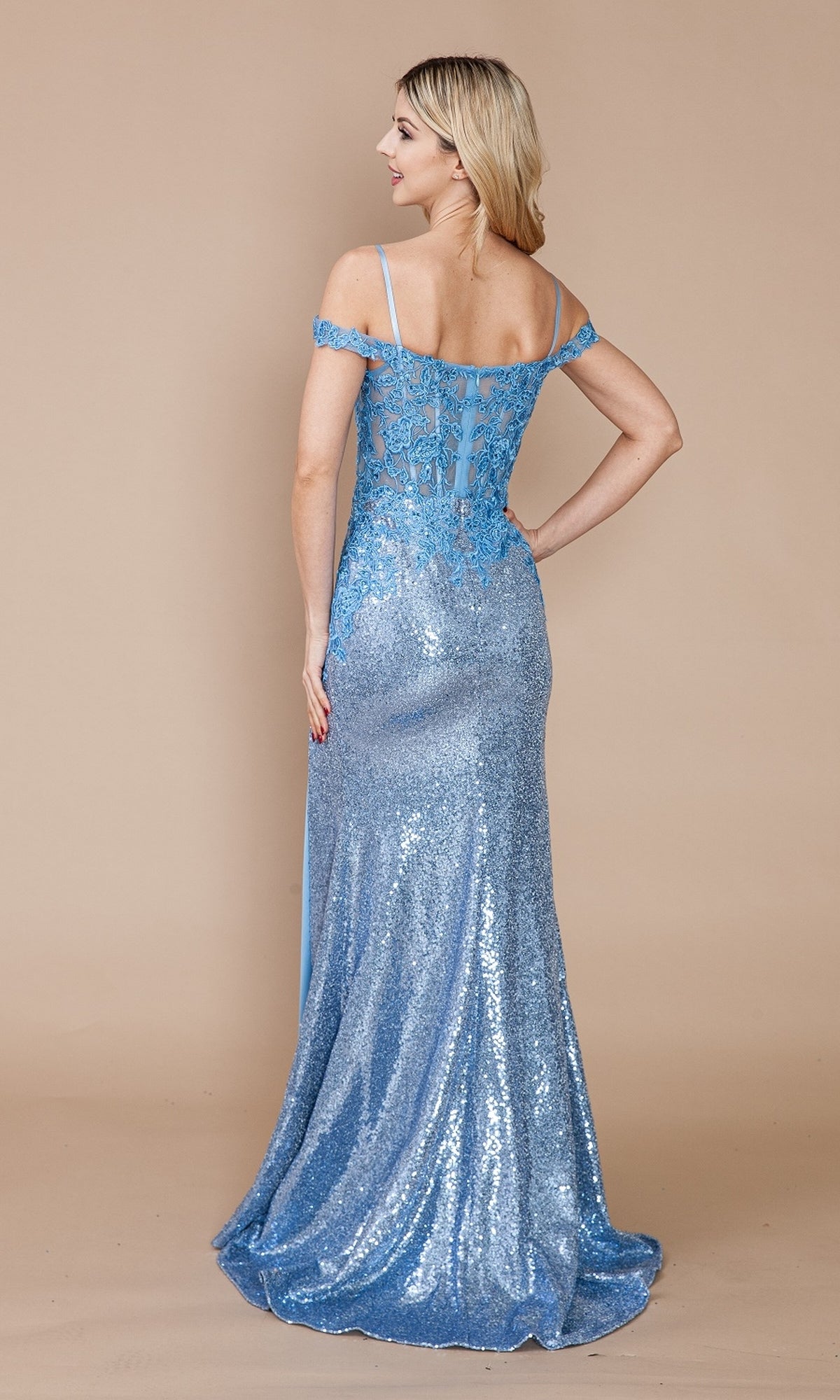A woman stands facing away in the Sheer-Corset Long Sequin Prom Dress: Poly USA 9398, showcasing its off-the-shoulder back details against a plain beige background.