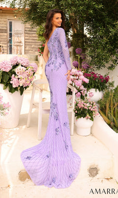 A woman in the One-Sleeve Beaded Long Formal Dress 94027, a fitted lavender gown with floral detailing, stands outdoors among pink and white flowers, facing slightly away from the camera.