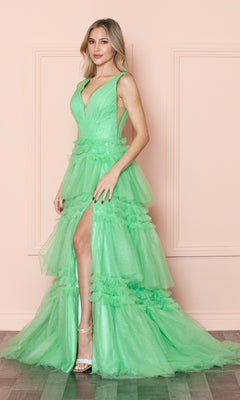 A woman stands indoors in the Poly USA 9406: a sleeveless, bright green ruffled long V-neck prom ball gown with a high slit, styled with strappy heels.