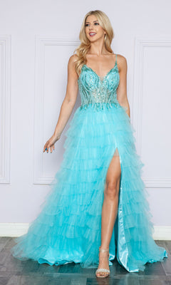 A woman in the Open-Back Long Ruffled Prom Dress: Poly USA 9408, featuring a light blue hue, beaded v-neck bodice, thin straps, high leg slit, and long ruffles, stands against a light-colored wall.