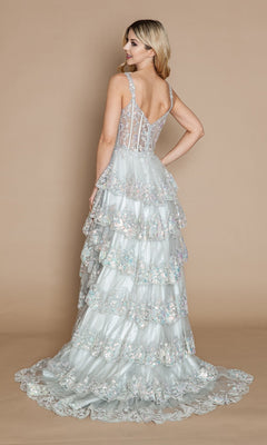 A woman faces away in the Sheer-Corset Long Ruffled Prom Dress (Poly USA 9410): a light blue, floor-length gown featuring floral embroidery, a sheer corset bodice, and delicate tiers, set against a plain beige background.