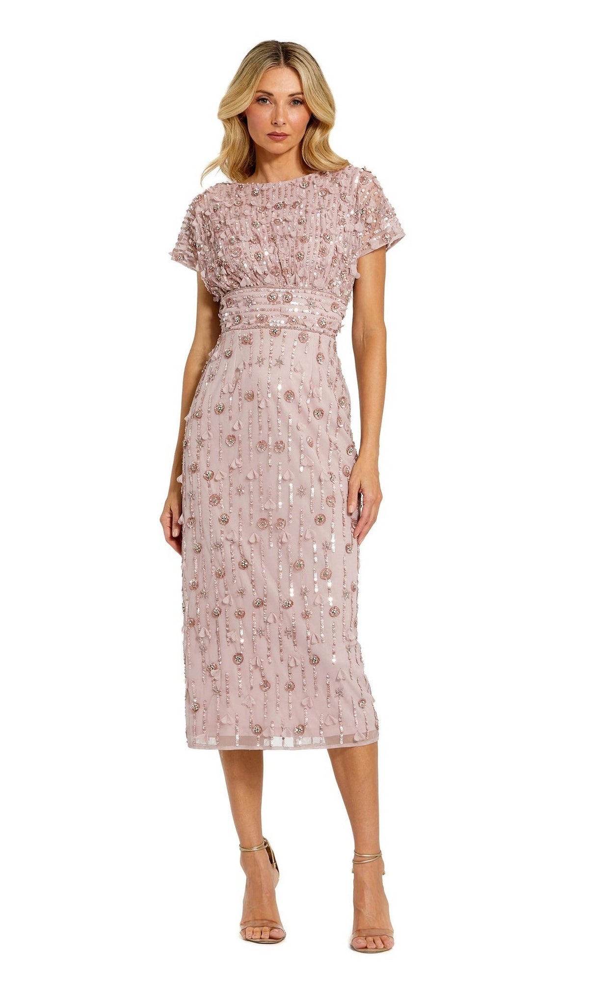 A woman wears the Mac Duggal Beaded Midi Wedding-Guest Dress 94117 in light pink, featuring short sleeves and sequin embellishments, styled with nude high-heeled sandals.