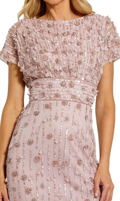 A woman wearing the Mac Duggal Beaded Midi Wedding-Guest Dress 94117—a light pink, short-sleeved dress with sequin stripes, beads, and textured geometric and floral embellishments.