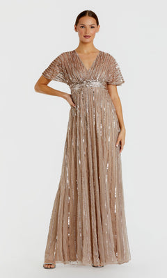 A woman poses against a plain white background wearing the Mac Duggal 94204 Long Formal Dress in taupe. This floor-length gown features short sleeves and vertical sequin stripes, with dazzling beaded details that create an effortlessly elegant look.