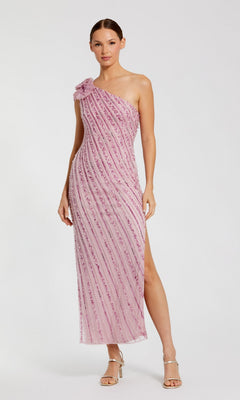 A woman wears the Mac Duggal 94221 long formal dress in orchid—an elegant one-shoulder, sequined beaded mesh midi with a side slit and floral detail—paired with silver high-heeled sandals.