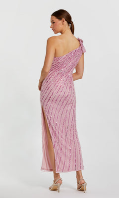 Woman wearing the Mac Duggal 94221 long formal dress in pink, featuring sequins, a one shoulder design, and side slit, stands in profile against a plain white background.