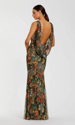 A woman stands against a plain white background wearing the Mac Duggal 94263 long formal dress—a sleeveless, floor-length floral mesh gown with subtle sequin accents and a low open back.