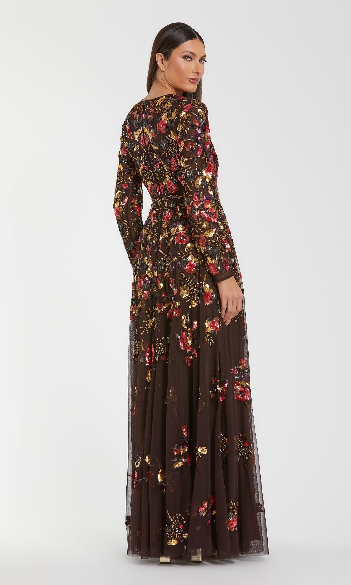 Woman wearing the Mac Duggal 94275 Long Sleeve Sequin Formal Dress, standing and looking over her shoulder against a plain white background.