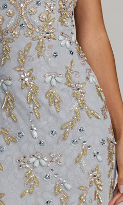 Close-up of the Mac Duggal 94311 long formal dress in light gray, showcasing intricate floral embroidery with delicate beadwork and sequins in gold, white, and silver hues. A woman’s arm can be seen beside the elegant sheath evening gown.