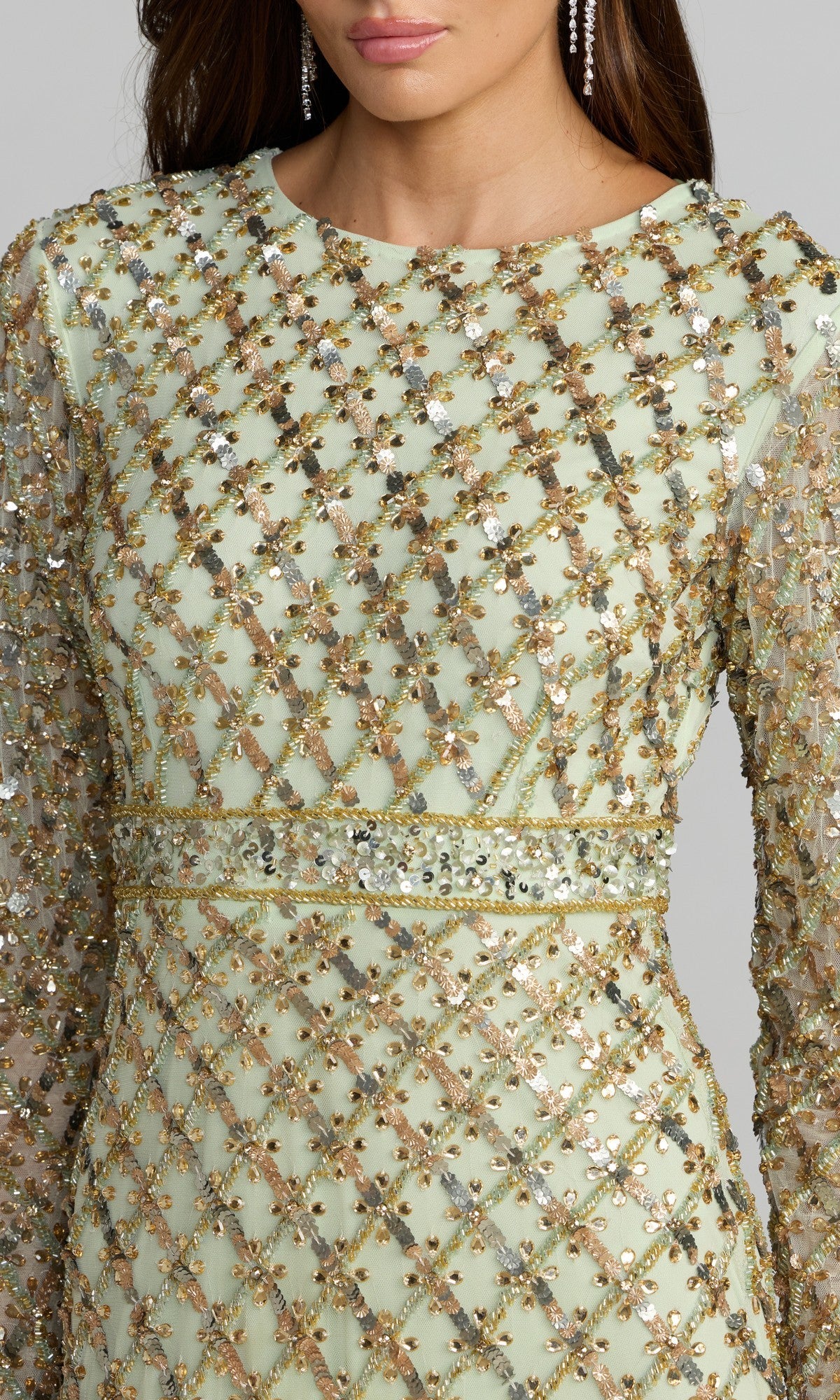 A woman wearing the Mac Duggal 94318 long formal dress in sage green, featuring a gold and silver sequin grid pattern; only her torso and lower face are visible.