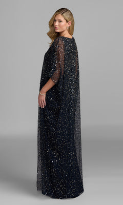Standing slightly sideways against a plain gray background, the woman wears the Mac Duggal 9475 long formal dress, a floor-length gown adorned with sequin beads and finished with sheer sleeves.