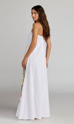 A woman stands sideways in the Mac Duggal 9498 Long Strapless Linen Dress with floral embroidery, set against a plain light background.