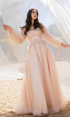 A woman stands outdoors in the Eureka 9505 Long Sleeve Strapless Long Prom Gown—light peach with an embroidered sweetheart bodice and sheer, detachable balloon sleeves—surrounded by billowing translucent fabric.