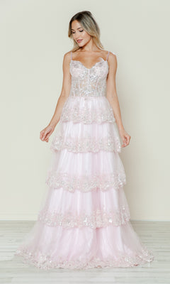 A woman wears the Long Glitter-Lace Tiered Prom Dress (Poly USA 9548) in blush—a sleeveless, spaghetti-strap gown with floral lace embellishments—standing against a plain light background.