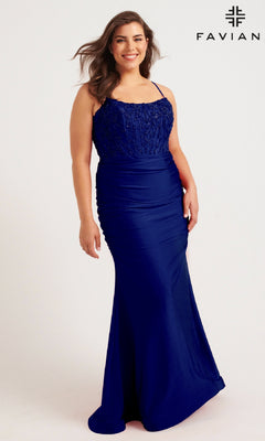 A woman models the Faviana 9569, a long plus-size prom dress in royal blue with lace and beaded corset bodice, standing against a plain background. The "FAVIAN" logo is displayed in the top right corner.