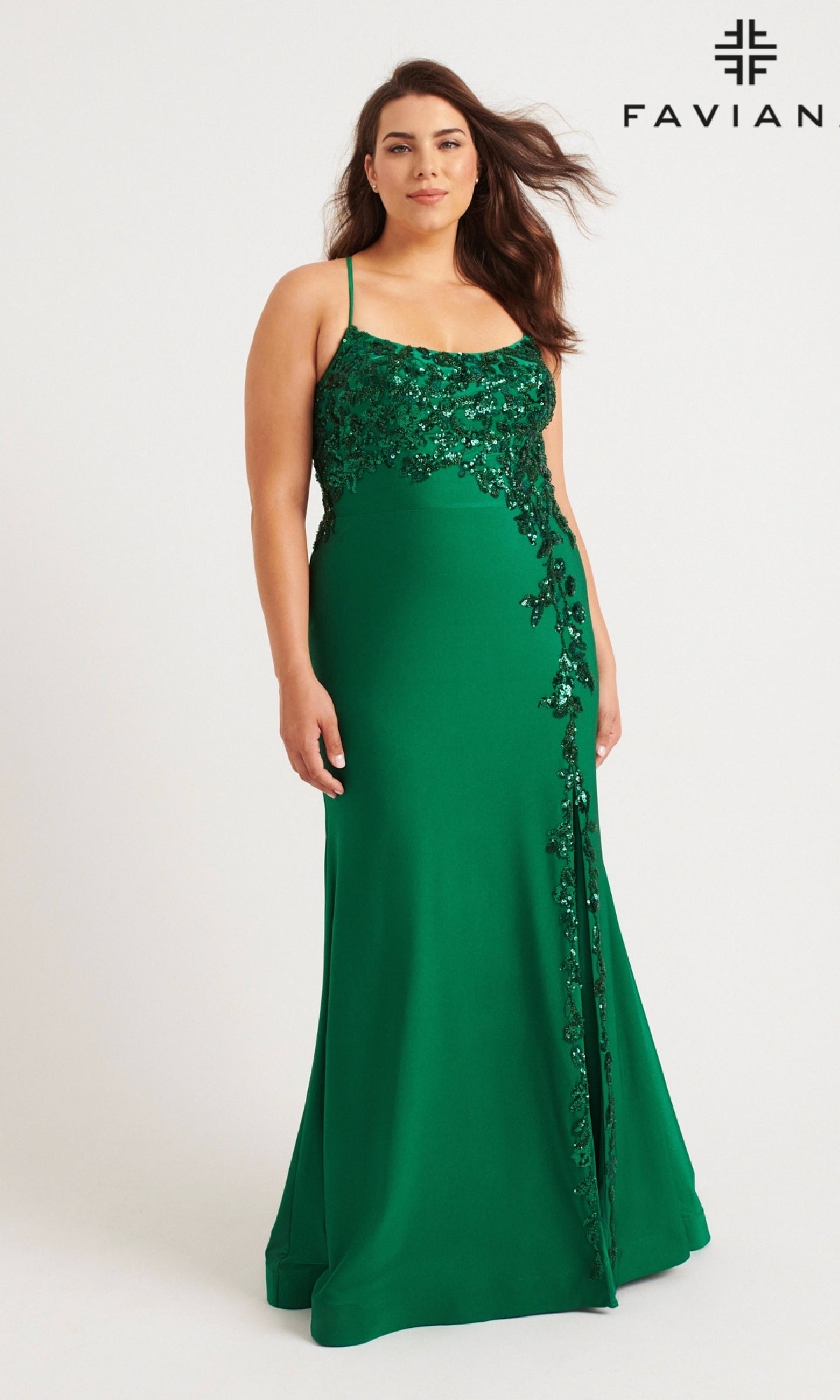 A woman models the Faviana 9570 Plus-Size Strappy Long Prom Dress, a sleeveless green gown with sequin floral designs, standing against a plain background with the Faviana logo in the top right corner.
