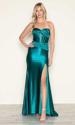 A woman models the Strapless Keyhole Long Prom Dress by Poly USA 9574, featuring a teal satin finish, corset-style bodice, and thigh-high slit, standing on a light wood floor with a plain beige background.