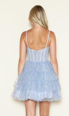 A woman with long blonde hair is seen from the back wearing the Short Sequin Ruffled Fit-and-Flare Hoco Dress 9546, a light blue party dress with thin straps, sparkly sequins, and a tiered tulle skirt against a plain background.
