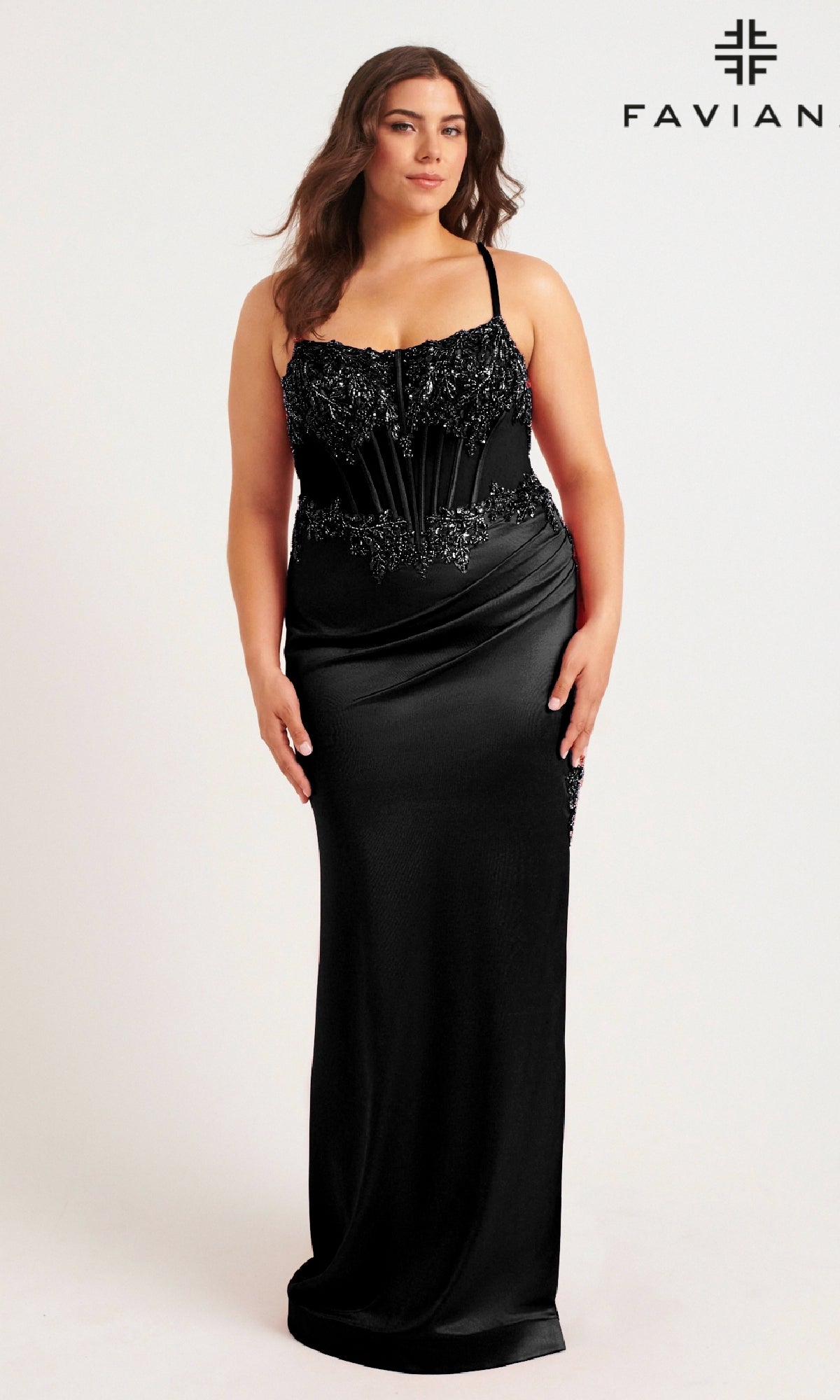 A woman models the Faviana 9592 long plus-size prom dress—a black, floor-length, sleeveless gown with a beaded corset bodice—against a plain white background. 
