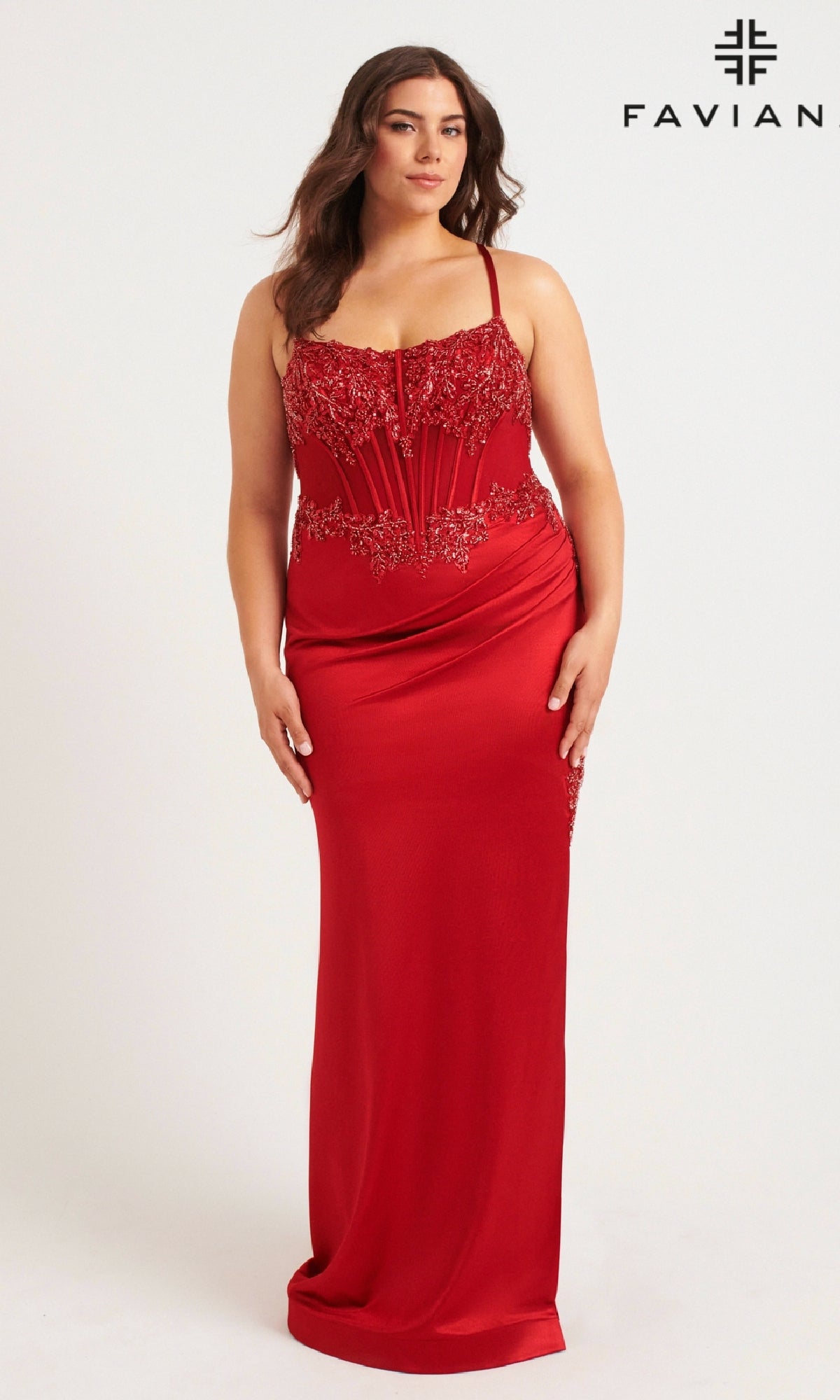 A woman models the Faviana 9592 Long Plus-Size Prom Dress, featuring a red, floor-length design with a beaded corset bodice and spaghetti straps, set against a plain white background. The Faviana logo appears in the top right corner.
