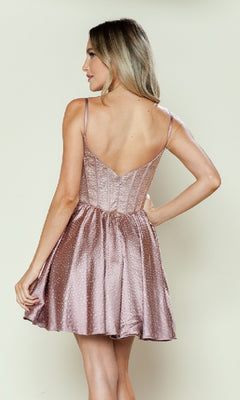 A woman with light brown hair models the Sparkly Homecoming Dress with Pockets: Poly USA 9594, a sleeveless, light pink satin corset dress with a fitted bodice and flared skirt, shown from the back.