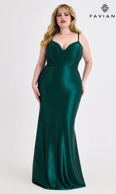 A woman in a fitted, floor-length emerald green Faviana 9600 Beaded-Corset Plus-Size Prom Gown stands against a white background. This elegant dress is ideal for making a statement at any special occasion.