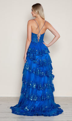 A woman faces away, wearing the Poly USA 9606 long prom dress—floor-length blue ruffles, flowy sequins, and a lace-up back.