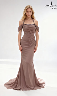 A woman wearing the Abby Paris 96092 long prom dress in mauve, featuring off-the-shoulder sleeves, beaded straps, a ruched bodice, and a flowing skirt, stands against a plain white background.
