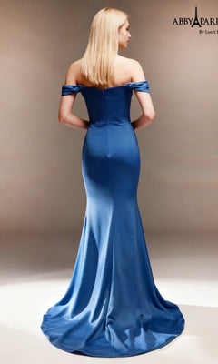 A woman stands facing away, wearing the Abby Paris 96094 Long Prom Dress—an off-the-shoulder satin formal gown in a stunning blue shade. The floor-length fitted skirt elegantly flares from the waist, beautifully enhancing the dress’s gracefully tailored bodice.