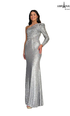 A woman modeling the Abby Paris 96097 long prom dress in silver—a one-shoulder, sequined formal gown with a single long sleeve—stands against a plain white background.