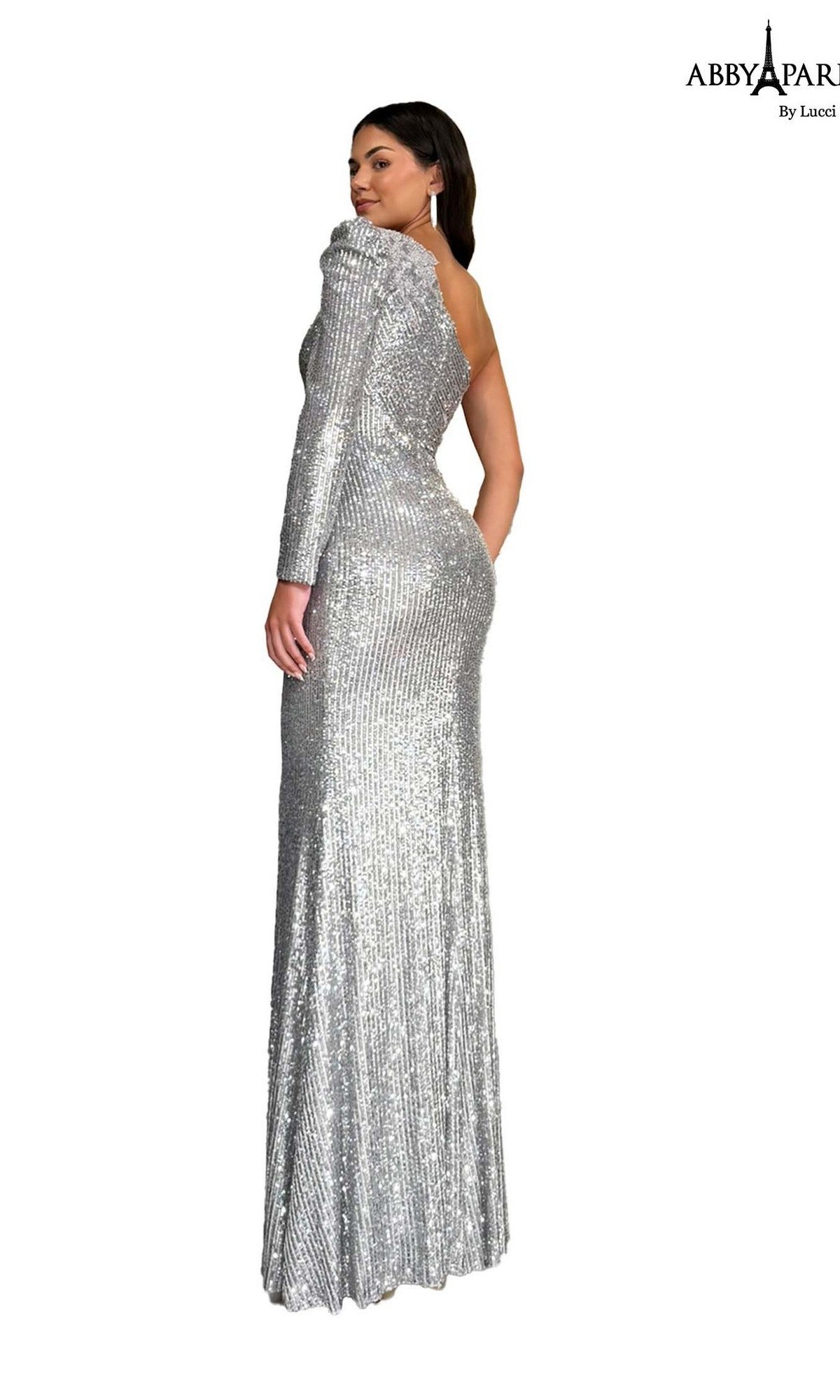 A woman stands with her back turned against a white background, wearing the Abby Paris 96097 long prom dress—a floor-length formal gown featuring silver sequins and a one-shoulder design.