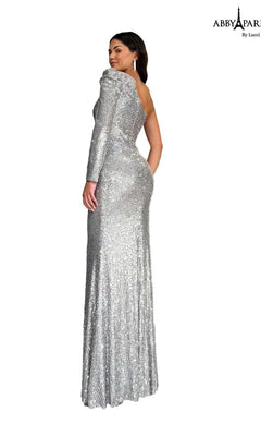 A woman stands with her back turned against a white background, wearing the Abby Paris 96097 long prom dress—a floor-length formal gown featuring silver sequins and a one-shoulder design.